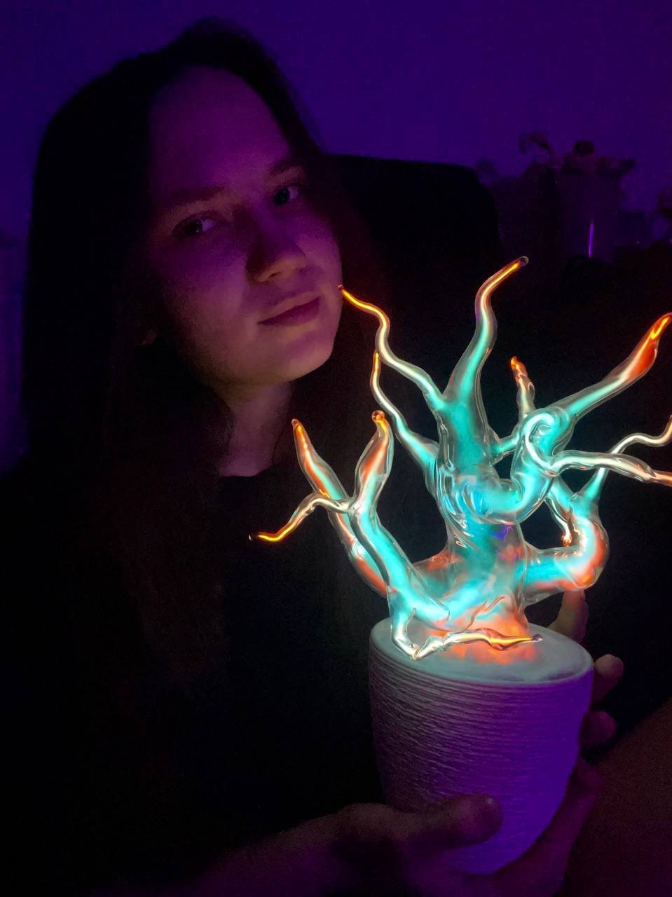 The glass part of a lamp held in hands